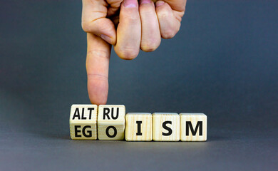 Altruism or egoism symbol. Concept words Egoism and Altruism on wooden cubes. Psychologist hand....