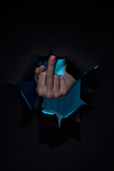 Fuck you sign by hand isolated on black background. Offensive gesture