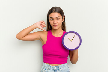 Young Indian woman holding a clock isolated on white background feels proud and self confident,...