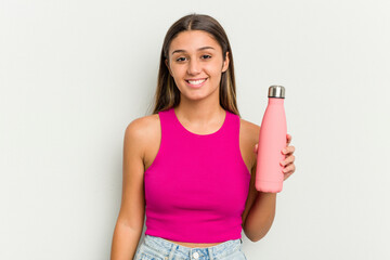 Young indian woman holding a pink thermo isolated on white background happy, smiling and cheerful.