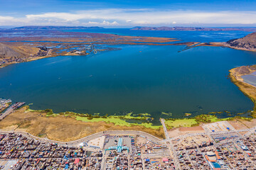 Aerial view of Lake Titicaca in Peru with the city of Puno and its port in the foreground..