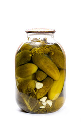 Glass jar with canned cucumbers on a white background