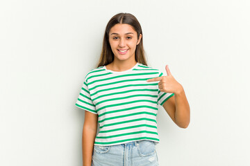 Young Indian woman isolated on white background person pointing by hand to a shirt copy space, proud and confident