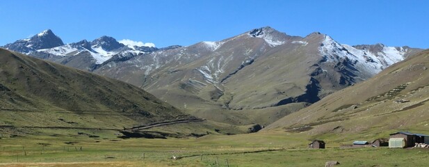 Panoramic view of a mountainous landscape in a rural area in Cusco, Peru, on a sunny day