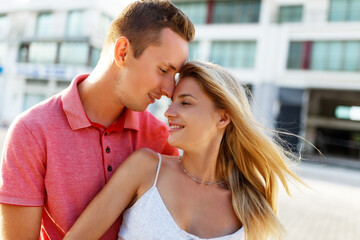 Lovely happy couple.Hugs together and smile in sunset light