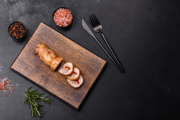 Fototapeta na wymiar Tasty baked meat roll of chicken meat, sweet pepper with spices and herbs