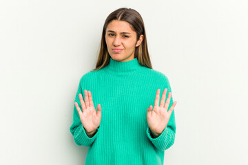 Young Indian woman isolated on white background rejecting someone showing a gesture of disgust.