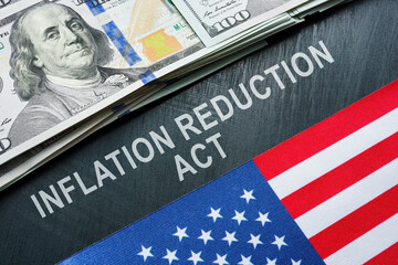 USA flag, dollars and inscription inflation reduction act.