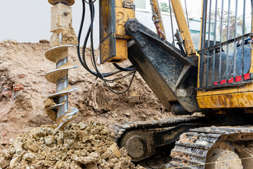 Hydraulic bore pile rig machine at the construction site.Drilling in the ground.Pile foundations.