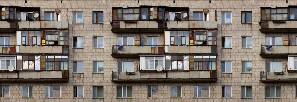 Seamless pattern with the facade of an old Soviet panel house in the Kazakh city of Pavlodar. Old balconies where things are stored and dried. Apartment building with windows