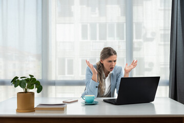 Frustrated annoyed woman confused by computer problem, annoyed businesswoman feels indignant about...