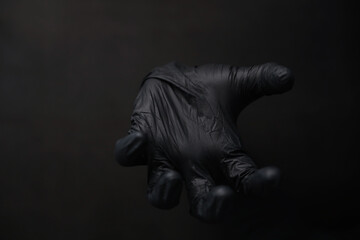 Background of hands in gloves. Black gloves. Hand gestures in black gloves.