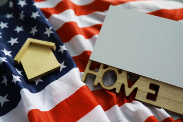 Fototapeta na wymiar House symbol on the American flag. Mortgage credit lending. Housing safety.