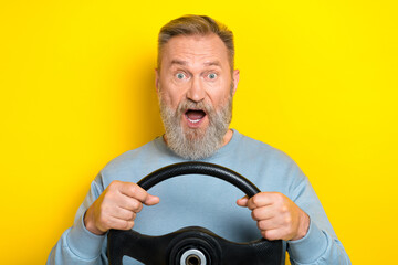 Photo of funny impressed retired guy wear blue sweater driving automobile open mouth isolated...