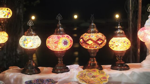 Turkish lamps of bright colors made of glass and mosaics at the bazar.