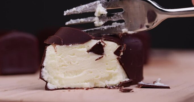 Take a fork of sweet curd cheese made from milk with milk chocolate, a sweet dessert made from dairy products and chocolate