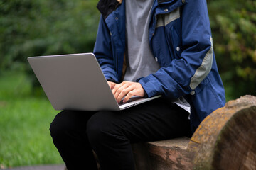 a male freelancer working outdoors using laptop. wireless technology
