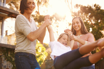 Three generations having great fun. Shot of a little girl playing outside with her mother and...