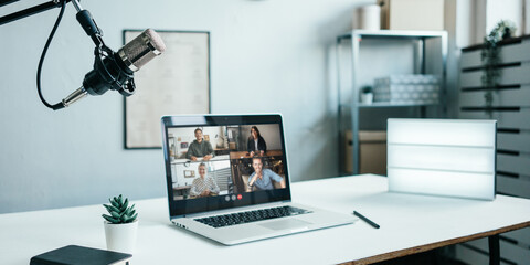 Laptop video call conference at loft studio. Team remote online meeting. Professional microphone