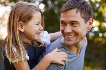 Youre my hero Dad. Shot of a father giving his adorable daughter a piggyback ride.