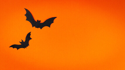 Orange cute Halloween background design with bats silhouettes copy space