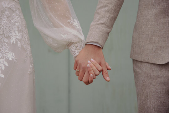 bride and groom holding hands