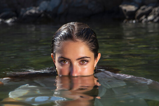 Sensual wet woman in clear lake water