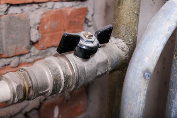 Black brass ball shut-off valves on water supply pipeline in the house, plumbing and construction concept