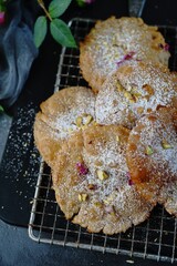 Meethe Chongay or Sweet poori topped with powdered sugar and nuts, selective focus