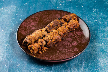 spicy bbq chicken seekh kabab served in a dish isolated on background top view