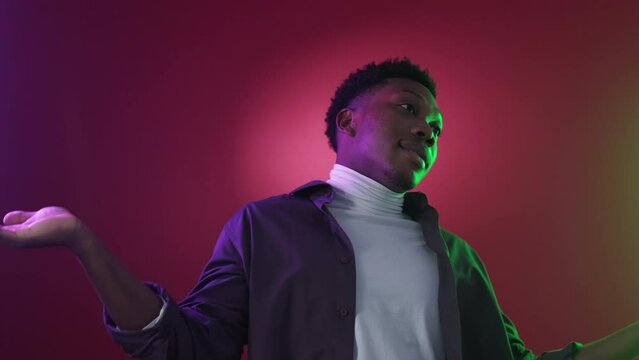 Shrug gesture. No idea. Careless sorry. Clueless indifferent confused man raising shoulders on pink purple red color gradient neon light.