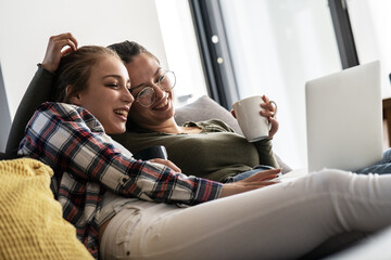 Lesbian LGTB couple relaxing at home.	
