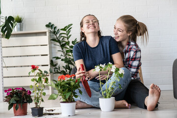 A lesbian couple planting flowers together for their home.	
