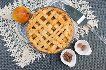Home made and healthy baked apple pie in glass plate, apple, cinnamon and nutmeg with beautiful gray and white background.