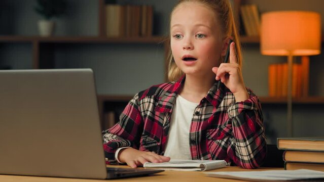 Creative child junior school girl thoughtful pupil kid doing homework watch educational video online use computer device for studying come up with super idea feel insight create answer to math task
