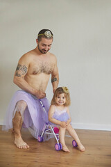 Father and daughter play dressed up as princesses