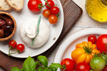Burrata cheese, various tomatoes and olives