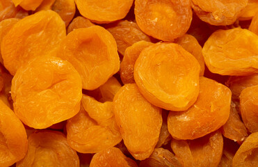 Dried apricots close up as a background. Heap of dried apricots on a white background.