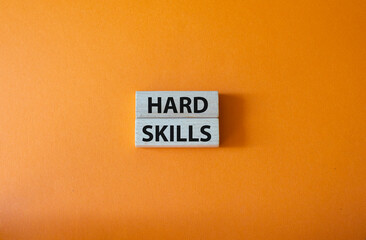 Hard skills symbol. Wooden blocks with words Hard skills. Beautiful orange background. Business and Hard skills concept. Copy space.