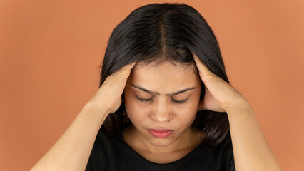 Portrait of a stressed woman on color background, sad depressed young girl isolated