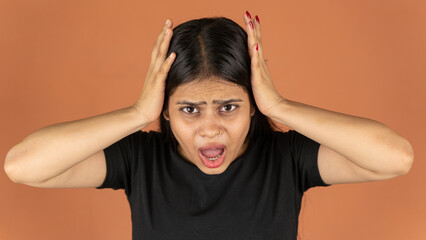 Portrait of a stressed woman on color background, sad depressed young girl isolated