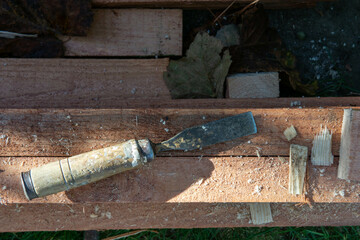 chisel used for work on wooden construction elements, planing of construction beams, woodworking with chisel 