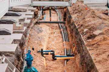 Excavation trench on a city street to replace plastic water pipes or laying cables. Repair and...