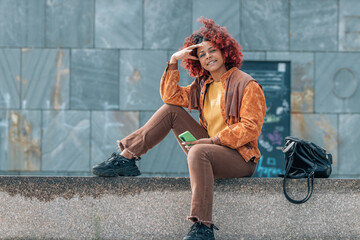 afro girl smiling in the street sitting