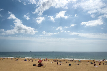 People enjoying their time on the beach in Carcavelos, Portugal