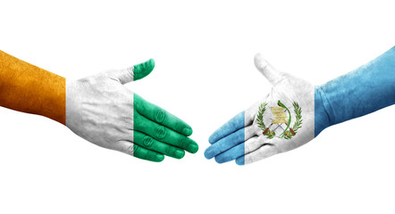 Handshake between Guatemala and Ivory Coast flags painted on hands, isolated transparent image.