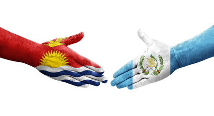 Handshake between Guatemala and Kiribati flags painted on hands, isolated transparent image.