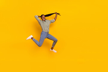 Fototapeta na wymiar Full size photo of crazy energetic person hands hold long hairdo isolated on yellow color background