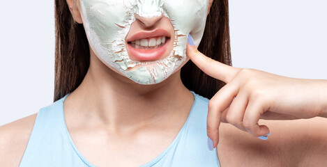 Beautician makes a face mask of a woman to rejuvenate the skin. Cosmetology treatment of problem...
