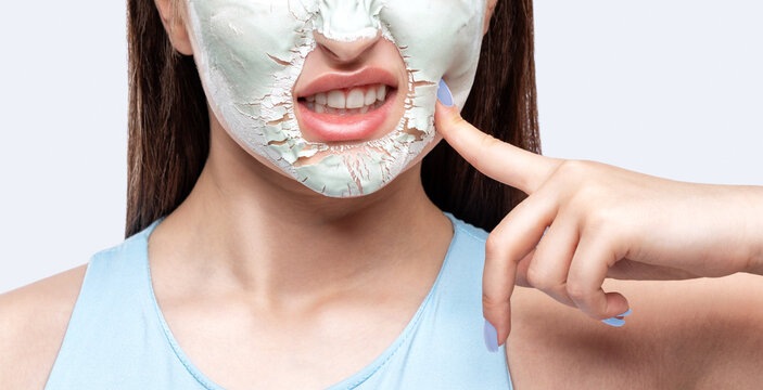 Beautician Makes A Face Mask Of A Woman To Rejuvenate The Skin. Cosmetology Treatment Of Problem Skin On The Face And Body.